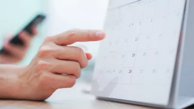 close up on employee man hand using finger pointing schedule (timetable) on calendar to make appointment meeting or manage timetable each day, life balance concept