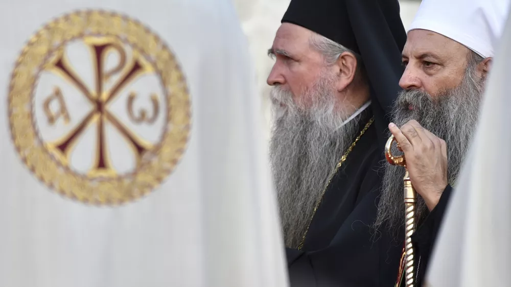 Head of the Serbian Orthodox Church, Patriarch Porfirije, right, and Mitropolitan Joanikije at the arrival ceremony in front of the Serbian Orthodox Church of Christ's Resurrection in Podgorica, Montenegro, Saturday, Sept. 4, 2021. Serbian patriarch Porfirije arrives at Podgorica ahead of the inauguration of the new bishop of the Serbian Orthodox Church in Montenegro scheduled in Cetinje, sparking tensions. On Saturday, hundreds of protesters confronted the police in Cetinje and briefly removed some of the protective metal fences around the monastery where the inauguration of Mitropolitan Joanikije is supposed to take place. (AP Photo/Risto Bozovic)