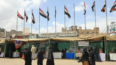 People walk past Yemeni flags in Sanaa, Yemen, Thursday, Sept. 17, 2026. (AP Photo/Osamah Abdulrahman)