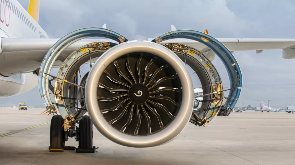Jet engine. A modern, new generation, jet-powered passenger aircraft is waiting at the airport. Aircraft parked with open hatches for jet engine maintenance.