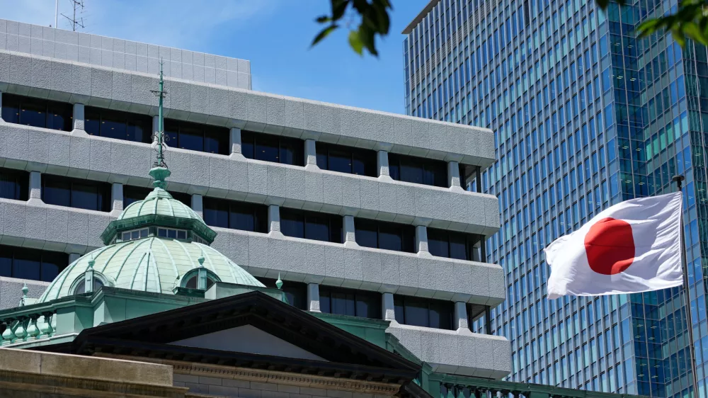 FILE - A Japanese flag flutters at the Bank of Japan headquarters in Tokyo, July 29, 2022. (AP Photo/Shuji Kajiyama, File)