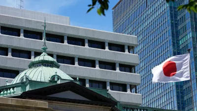 FILE - A Japanese flag flutters at the Bank of Japan headquarters in Tokyo, July 29, 2022. (AP Photo/Shuji Kajiyama, File)