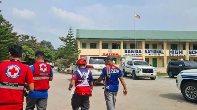 In this handout photo provided by the Philippine Red Cross, Red Cross members arrive at Banga National High School in the town of Banga, Philippines, Friday, Sept. 18, 2026. (Philippine Red Cross via AP)