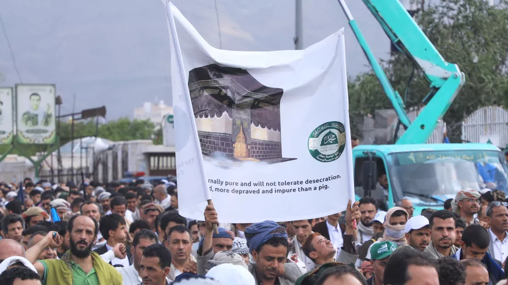 Supporters of Yemen's Houthi rebels raise a banner during a rally in support of the group and to protest Saudi Arabia's accusation that the Houthis targeted Islam's holiest site of Mecca, in Sanaa, Yemen, Friday, Sept. 18, 2026. (AP Photo/Osamah Abdulrahman)
