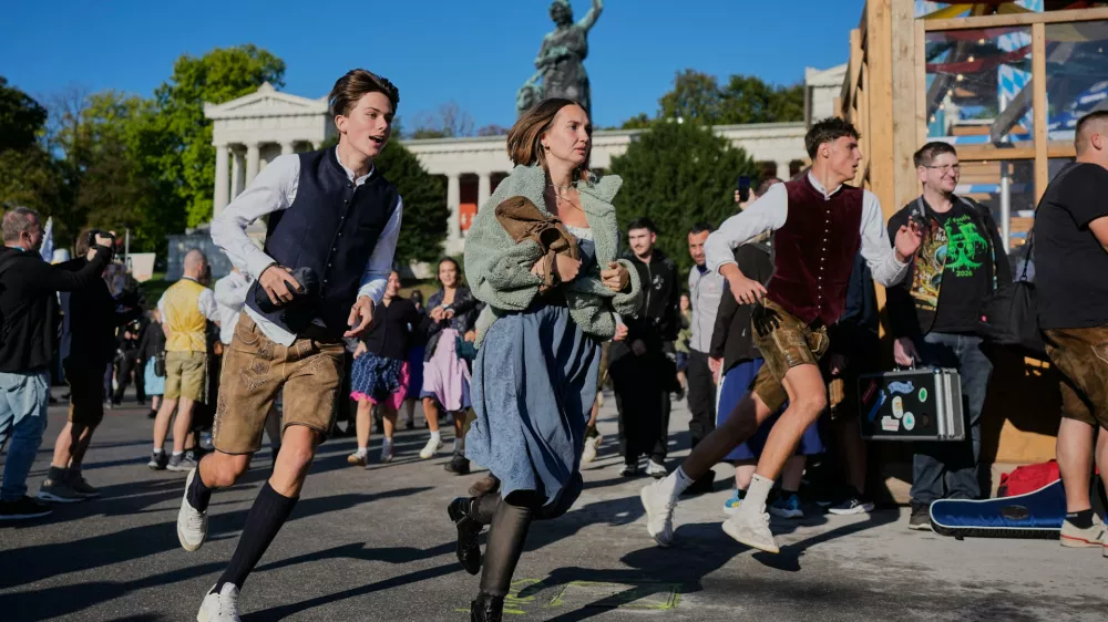 People run to enter the 191st Oktoberfest beer festival in Munich, Germany, Saturday, Sept.19, 2026. (AP Photo/Matthias Schrader)