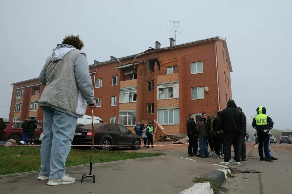 People gather outside a damaged residential building following what authorities described as a Ukrainian drone strike, amid the Russia-Ukraine conflict in Sofyino settlement in the Ramensky district of the Moscow region, Russia, September, 20, 2026. REUTERS/Stringer
