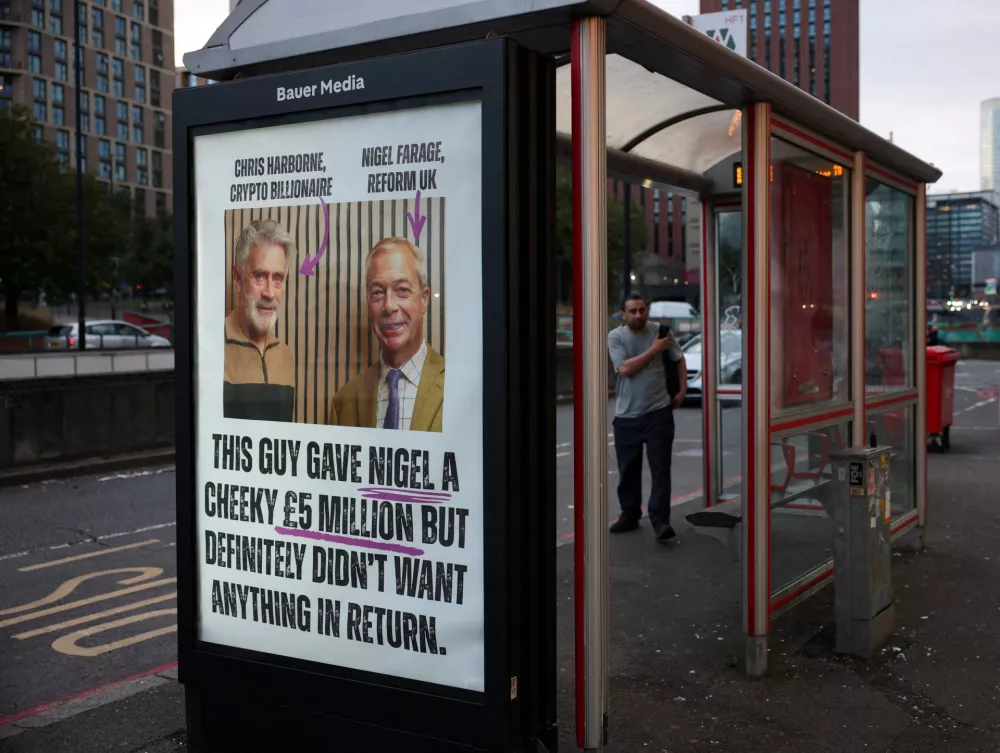 A bus stop displays a poster placed by protest group Climate Resistance as part of its "Resist Reform" campaign, to expose Nigel Farage's and the Reform UK party's financial links to billionaire Christopher Harborne, in Birmingham, Britain, September 3, 2026. REUTERS/Isabel Infantes