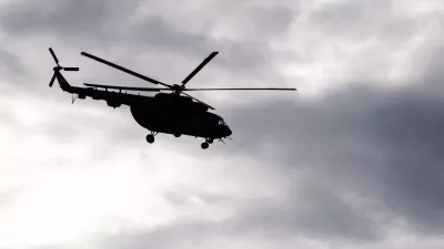 Silhouette of S Soviet helicopter Mi-8 common operational military aircraft aloft in the air cloudy sky