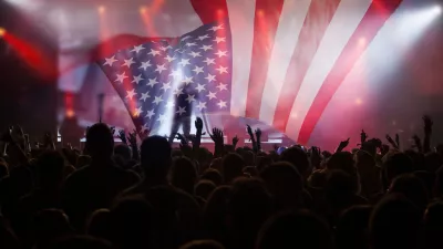 Crowd of people celebrating Independence Day. United States of America USA flag with fireworks background for 4th of July.