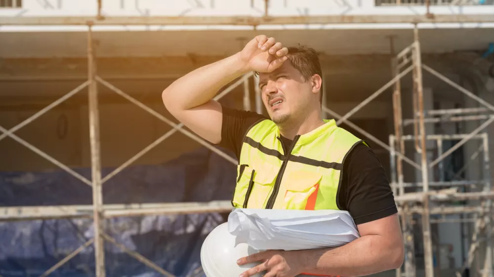 Male construction engineer worker working feeling tired and thirst of water at construction site