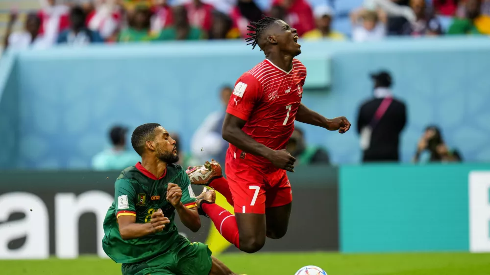 Cameroon's Jean-Charles Castelletto, left, vies for the ball with Switzerland's Breel Embolo during the World Cup group G soccer match between Switzerland and Cameroon, at the Al Janoub Stadium in Al Wakrah, Qatar, Thursday, Nov. 24, 2022. (AP Photo/Petr Josek)