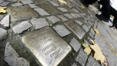 Pedestrians walk past so-called 'Stolpersteine' (stumbling blocks), memorial pavement plaques commemorating German Jews who died in the concentration camps of Auschwitz and Theresienstadt, in Berlin's Wilmersdorf district November 7, 2008. German artist Gunter Demnig has embedded into pavements across Germany, Austria, Hungary and the Netherlands where Jews were living during the Nazi era.    REUTERS/Fabrizio Bensch (GERMANY) - BM2E4B715CC01