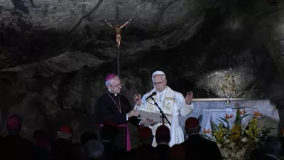 Pope Leo XIV prays at the Grotto of the Apparitions of Massabielle, in Lourdes, France, Saturday, Sept. 26, 2026. (AP Photo/Laurent Cipriani)
