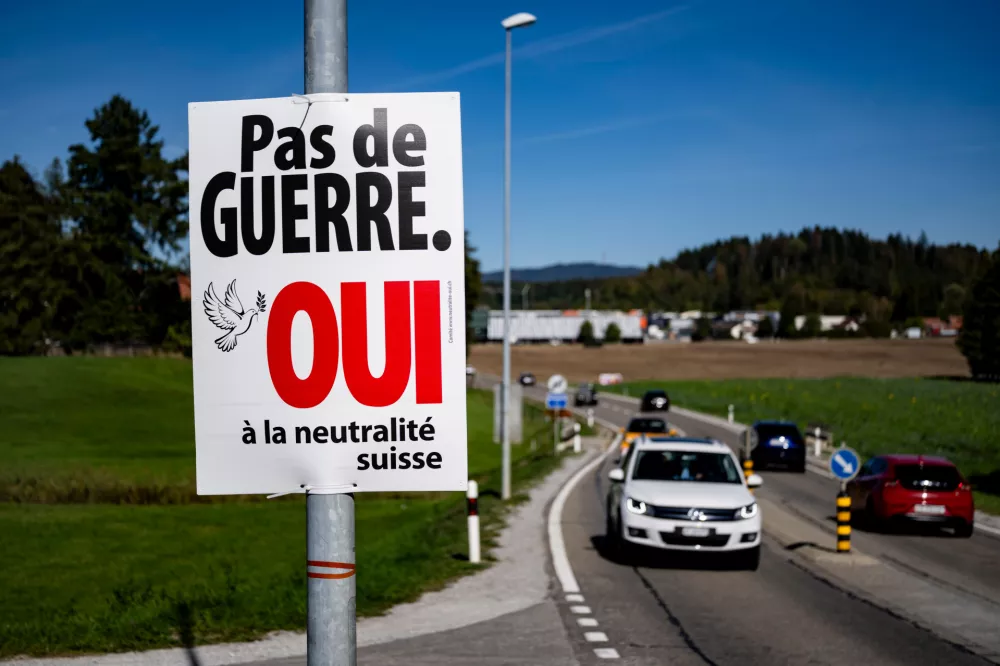 An electoral poster reads "No war, Yes to Swiss neutrality" is posted along a road in Epagny, Switzerland, Friday, Sept. 25, 2026. (Jean-Christophe Bott/Keystone via AP)