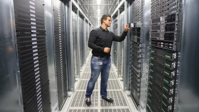 System administrator Benjamin Fischer checks a server in the new computer center of Deutsche Telekom AG in Biere, Germany, 01 July 2014. The subsidiary T-Systems will open the largest computing center in Germany on 03 July 2014 with an area of 150,000 square meters. There will be 30,000 servers here and 100 employees. Together with the center in Magdeburg, the "TwinCore" allows for applications and client data to be handled in parallel at two locations for security reasons. T-Systems wants to satisfy the high demand for cloud service by companies with the facility. Photo by: Jens Wolf/picture-alliance/dpa/AP Images