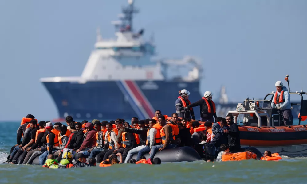 FILE - A group of migrants try to cross the channel from France to Britain on a dinghy boat, in Hardelot, northern France, Wednesday, Sept. 23, 2026. (AP Photo/Jean-Francois Badias, File)