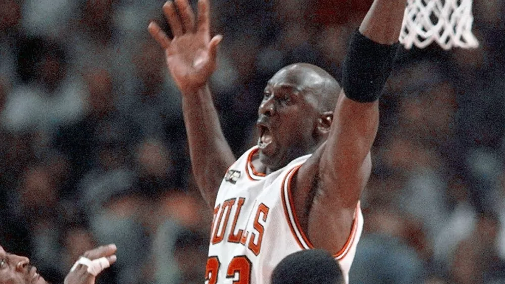 FILE - In this June 10, 1998, file photo, Cicago Bulls' Michael Jordan reaches high above teammates Dennis Rodman, left, Scottie Pippen, and Scott Burrell (24) for a rebound against the Utah Jazz in the second half of Game 4 in the NBA Finals in Chicago. Jordan described his final NBA championship season with the Chicago Bulls as a &acirc;&euro;śtrying year.&acirc;&euro;ť &acirc;&euro;śWe were all trying to enjoy that year knowing it was coming to an end,&acirc;&euro;ť Jordan told Good Morning America on Thursday, April 16, 2020. (AP Photo/Michael S. Green, File)