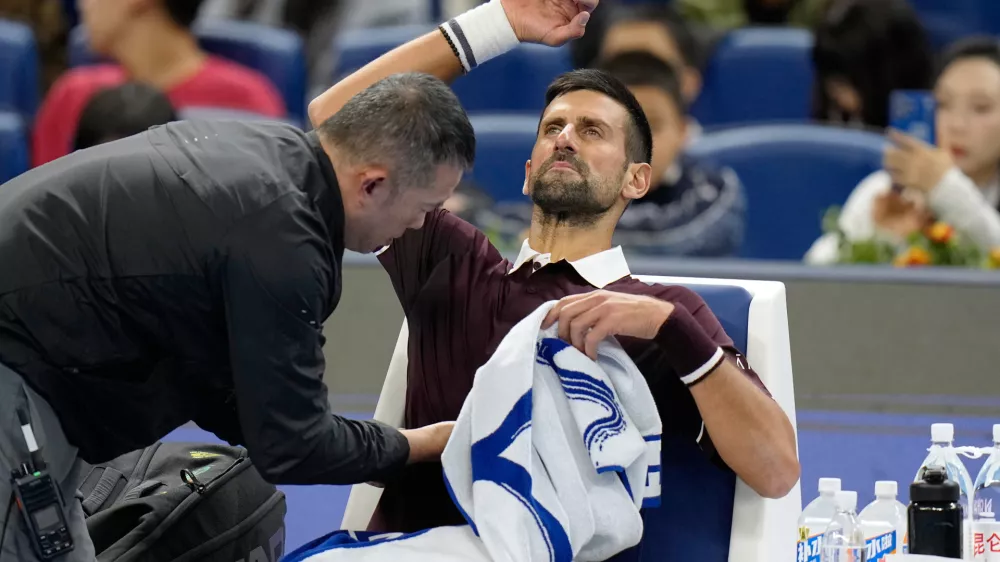 Novak Djokovic of Serbia receives a medical timeout during the first round of the men's singles match against Nuno Borges of Portugal in the China Open tennis tournament in Beijing, Wednesday, Sept. 30, 2026. (AP Photo/Andy Wong)