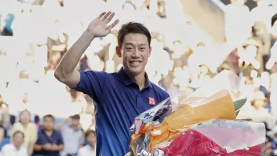 Japan's Kei Nishikori waves as he leaves the court following his first round loss to Frances Tiafoe of the U.S., at the Japan Open tennis championship in Tokyo, Thursday, Oct. 1, 2026. (Daiki Katagiri/Kyodo News via AP)