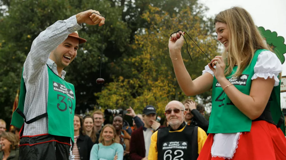 Competitors take part in the first round of the annual World Conker Championships in Southwick, Britain, October 12, 2025. REUTERS/Temilade Adelaja