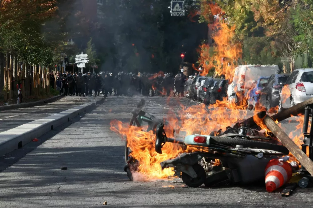 View of burning Velib bicycle, garbage bins and objects set up by high school and university students in a street amid clashes with French riot police during a student protest to demand the hiring of substitute teachers, increased resources and better learning conditions, and to support the ongoing high-school student movement in the Seine-Saint-Denis department, in Saint-Denis near Paris, France, October 1, 2026. REUTERS/Abdul Saboor