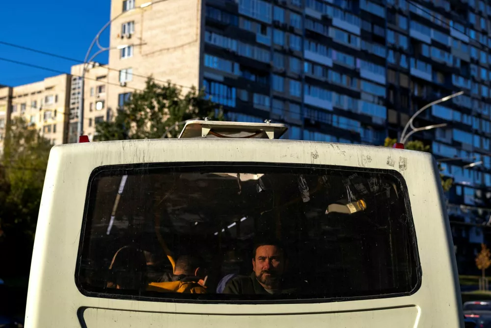 A man looks out from the back of a bus that is stuck in traffic headed to the left bank of the city, after Russian jet drone strikes on Kyiv's bridges caused disruptions, amid Russia's attack on Ukraine, in Kyiv, Ukraine October 2, 2026. REUTERS/Thomas Peter