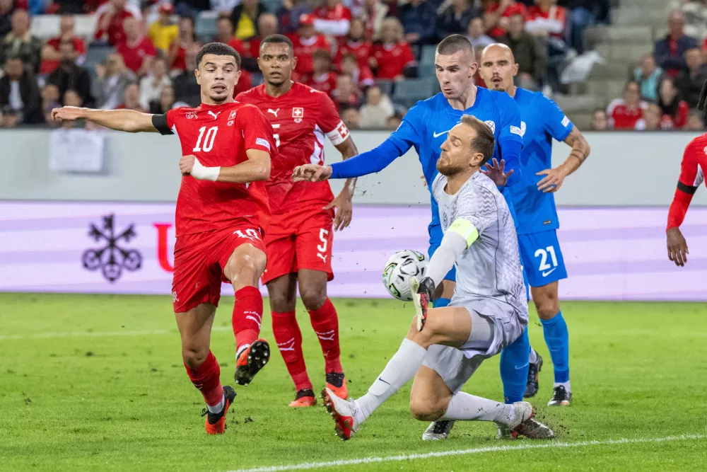 Zeki Amdouni, left, from Switzerland plays against Jan Oblak, right, from Slovenia during the UEFA Nations League soccer match between Switzerland and Slovenia in Lucerne, Switzerland, Saturday, Oct. 3, 2026. (Urs Flueeler/Keystone via AP)