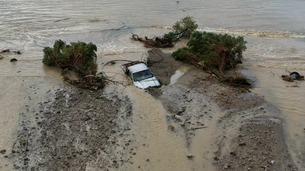 A drone view of a car and trees washed into the sea, after heavy rain continues to affect parts of Crete, prompting authorities to maintain severe weather warnings, in Therma near Ierapetra, Crete island, Greece, October 3, 2026. REUTERS/Stefanos Rapanis   TPX IMAGES OF THE DAY