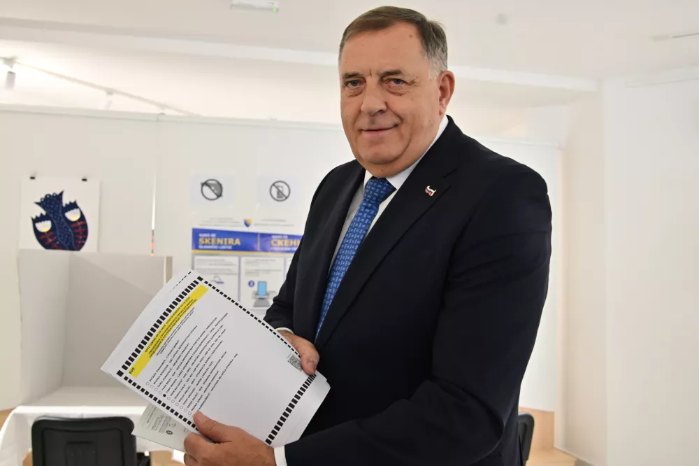 Milorad Dodik, former president of the Serb-majority Republika Srpska shows a ballot paper at a polling station in Laktasi, northwest of Sarajevo, Bosnia, Sunday, Oct. 4, 2026. (AP Photo/Radivoje Pavicic)