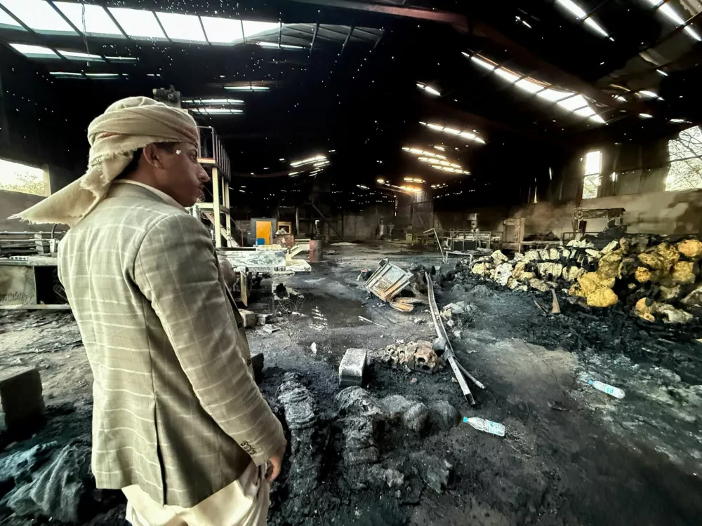 A man stands at a factory damaged by an airstrike in Sanaa, Yemen October 4, 2026. REUTERS/Stringer   TPX IMAGES OF THE DAY