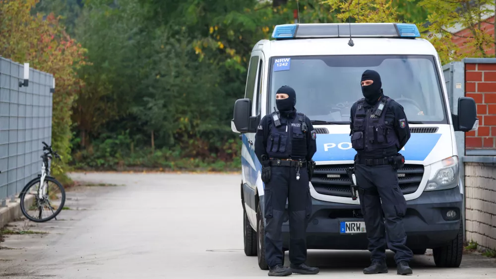 Police officers are stationed at the entrance to the home of former president of the Federal Intelligence Service, or BND, August Hanning, 80, who was arrested on suspicion of espionage, in Nordwalde, Germany, Tuesday, Oct. 6, 2026. (Christoph Reichwein/dpa via AP)