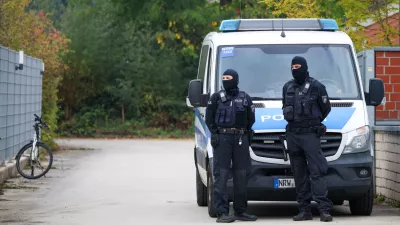 Police officers are stationed at the entrance to the home of former president of the Federal Intelligence Service, or BND, August Hanning, 80, who was arrested on suspicion of espionage, in Nordwalde, Germany, Tuesday, Oct. 6, 2026. (Christoph Reichwein/dpa via AP)