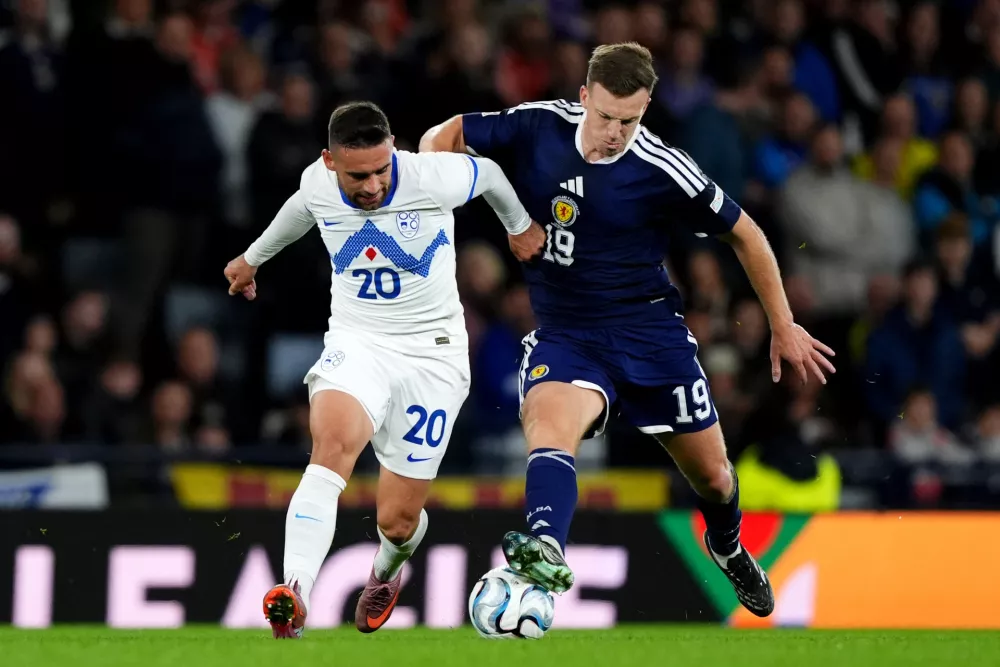 Slovenia's Aljosa Matko, left, and Scotland's Lewis Ferguson battle for the ball during the Nations League soccer match between Scotland and Slovenia in Glasgow, Scotland, Tuesday Oct. 6, 2026. (Andrew Milligan/PA via AP)