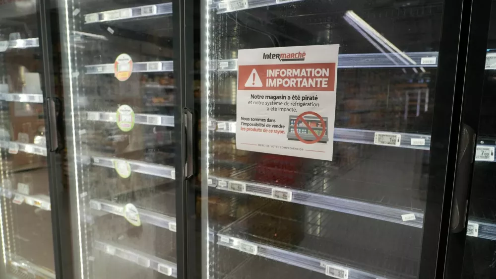View of empty refrigerators at the frozen food aisle inside an Intermarche supermarket in Paris the day after a cyberattack targeted refrigeration systems at French supermarket chains, causing food losses and fires at several stores, France, October 13, 2026. The placard reads "Important information. Our store has been hacked, and our refrigeration system has been affected." REUTERS/Lucien Libert