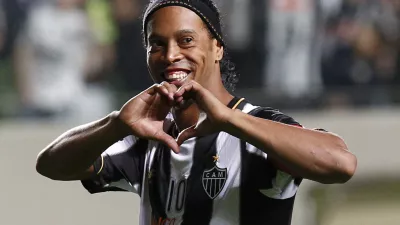 FILE - In this July 11, 2013 file photo, Brazil's Atletico Mineiro's Ronaldinho celebrates his team's victory over Argentina's Newell's Old Boys at the end of a Copa Libertadores semifinal soccer match in Belo Horizonte, Brazil. The brother and agent of 2005 Ballon d'Or winner Ronaldinho says the former Brazil and Barcelona playmaker has retired from football. (AP Photo/Bruno Magalhaes, File)