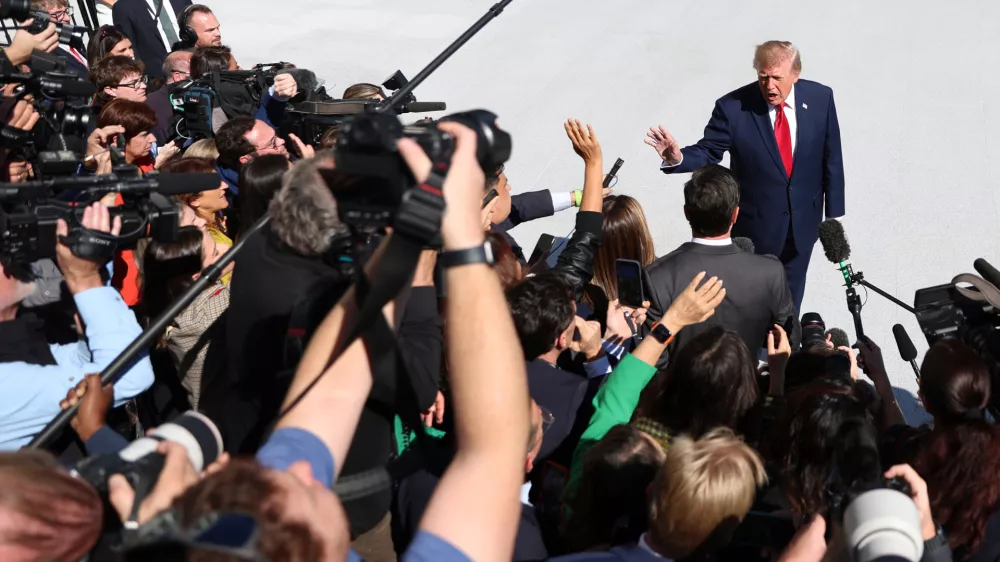 President Donald Trump speaks to reporters before boarding Marine One at the White House on Wednesday, Oct. 7, 2026, in Washington. (AP Photo/Tom Brenner)