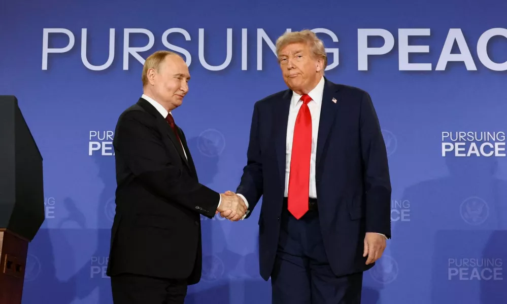 FILE PHOTO: U.S. President Donald Trump and Russian President Vladimir Putin shake hands during a press conference following their meeting to negotiate an end to the war in Ukraine, at Joint Base Elmendorf-Richardson, in Anchorage, Alaska, U.S., August 15, 2025. REUTERS/Kevin Lamarque/File Photo