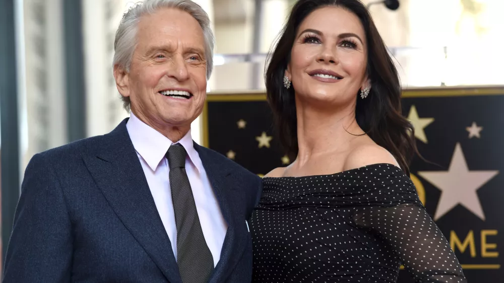FILE - Actor Michael Douglas, left, and his wife Catherine Zeta-Jones appear at a ceremony honoring him with a star on the Hollywood Walk of Fame in Los Angeles on Nov. 6, 2018. (Photo by Chris Pizzello/Invision/AP, File)