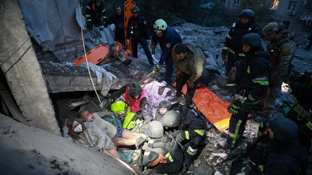 Rescue workers pull a family from the rubble of a residential building destroyed by a Russian airstrike in Zaporizhzhia, Ukraine, Saturday, Oct. 10, 2026. (AP Photo/Kateryna Klochko)