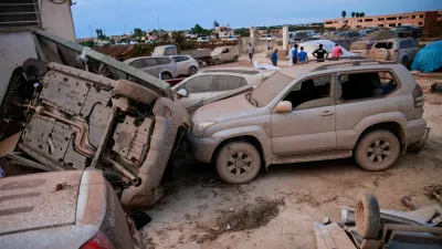 An overturned vehicle rests against a mud-covered one after a tornado struck Marsala, Sicily, Italy, October 9, 2026. REUTERS/Antonio Cascio