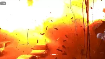 Surveillance footage shows vehicles parked on a street as debris falls during an explosion from a Russian strike, amid Russia's attack on Ukraine, in Kharkiv, Ukraine, October 11, 2026, in this frame from a handout video. Kharkiv Prosecutor's Office/via REUTERS THIS IMAGE HAS BEEN SUPPLIED BY A THIRD PARTY. MANDATORY CREDIT. NO RESALES. NO ARCHIVES. OVERLAY FROM SOURCE. VERIFICATION: Reuters verified the location from the buildings, business sign, sidewalk and road layout that matched the archive and satellite imagery from the area. Coordinates: 49.9630569, 36.0963842. The date was verified by corroborating official reports from the Kharkiv State of Emergency Service and the Regional Governor Oleh Syniehubov about the strike on October 11. No old results were found posted online before October 11.