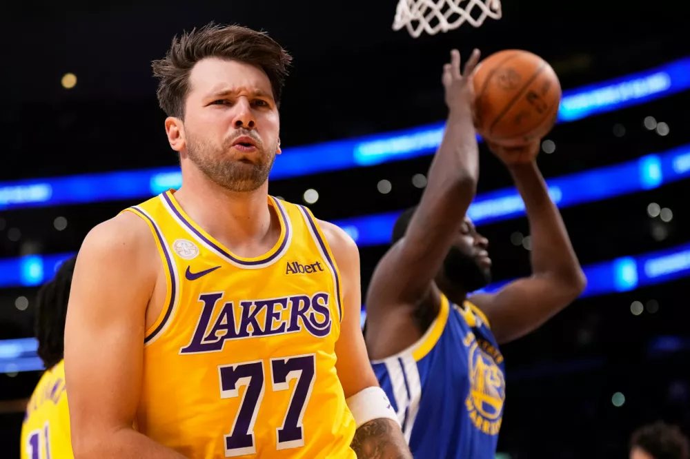 Los Angeles Lakers forward/guard Luka Doncic, left, looks to fans after scoring as Golden State Warriors forward/center Draymond Green takes the ball during the first half of an NBA basketball game Wednesday, Oct. 21, 2026, in Los Angeles. (AP Photo/Mark J. Terrill) / Foto: Mark J. Terrill