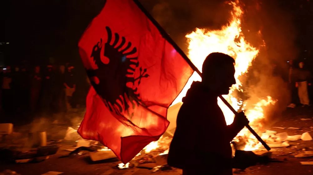 A protester holds an Albanian national flag as Albanian students hold an anti-government protest in Tirana, Albania, October 13, 2026. REUTERS/Florion Goga
