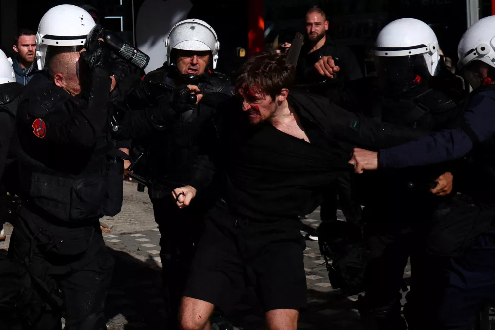 Police officers hold a demonstrator as Albanian students hold an anti-government protest in Tirana, Albania, October 13, 2026. REUTERS/Florion Goga   TPX IMAGES OF THE DAY