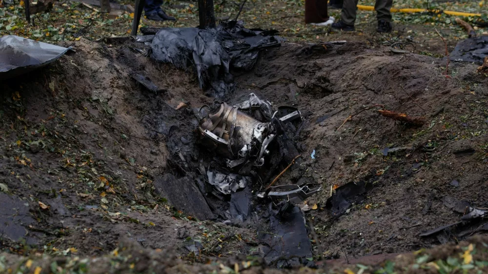 Wreckages of a Russian jet powered drone lay inside a crater that appeared at the site of a residential area after a strike, amid Russia's attack on Ukraine, in Kyiv, Ukraine October 15, 2026. REUTERS/Valentyn Ogirenko