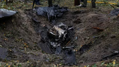 Wreckages of a Russian jet powered drone lay inside a crater that appeared at the site of a residential area after a strike, amid Russia's attack on Ukraine, in Kyiv, Ukraine October 15, 2026. REUTERS/Valentyn Ogirenko
