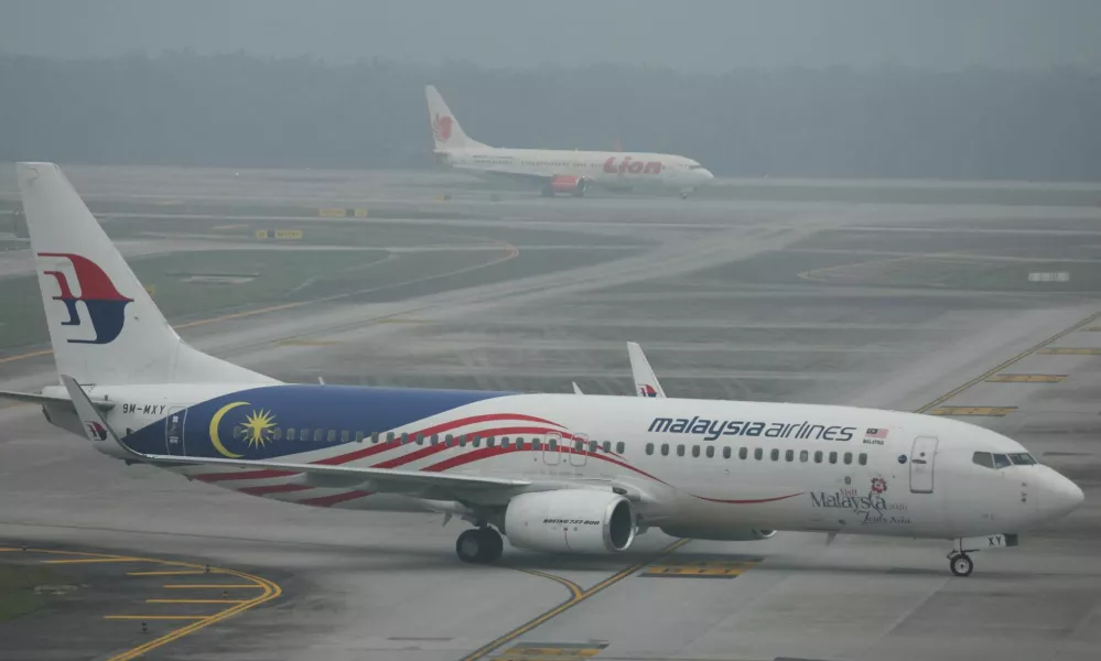 Malaysia Airlines and Lion Air aircraft on the haze-shrouded tarmac at Kuala Lumpur International Airport in Sepang, Malaysia, October 14, 2026. REUTERS/Hasnoor Hussain