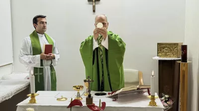 This picture released by Vatican Media on Friday, Oct. 16, 2026, shows Pope Leo XIV, flanked by his personal secretary monsignor Edgard Iv&aacute;n Rimaycuna Inga, left, celebrating Mass at the Agostino Gemelli Polyclinic in Rome where he's recovering after he had a cancer removed from his right lung. (Vatican Media via AP)