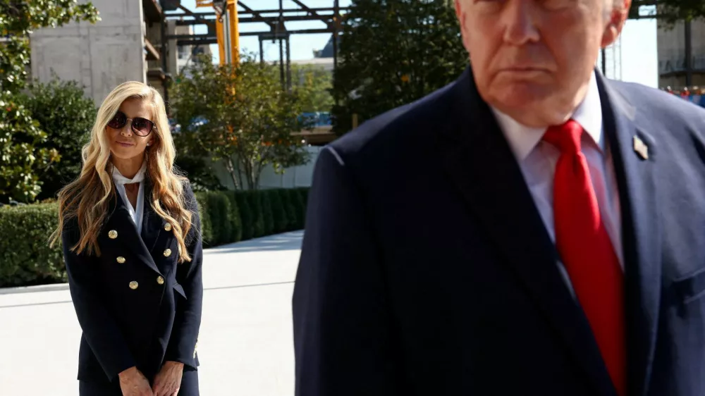 FILE PHOTO: New White House Press Secretary Katie Zacharia stands behind US President Donald Trump as he departs the White House in Washington, DC, US, October 13, 2026.  REUTERS/Kevin Lamarque/File Photo