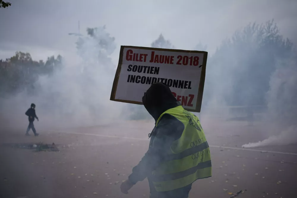 A protesters holds a placard reading "Yellow vests 2018, unconditional support," during a demonstration against rising living costs, joining students' grievances, in Lyon, France, Saturday, Oct. 17, 2026. (AP Photo/Laurent Cipriani)